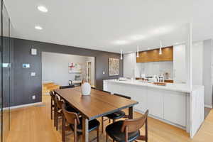 Dining space with recessed lighting and light wood-style floors