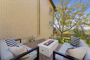Wooden terrace with an outdoor living space with a fire pit