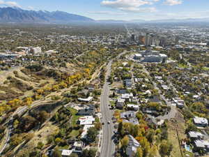 Aerial view of property and surrounding area with a mountain backdrop