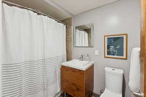 Full bath featuring vanity and curtained shower