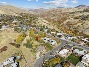 Aerial view of property's location with mountains and nearby suburban area
