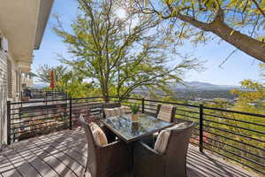 Deck with outdoor dining space and views of the Oquirrh Mountains.