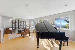 Sitting room with light wood-style flooring and recessed lighting