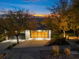 View of front of home featuring driveway and a shingled roof