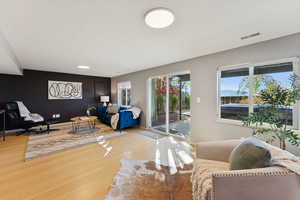 Living room featuring wood finished floors and baseboards. Walkout to hot tub.
