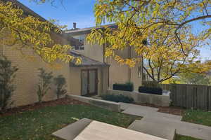 View of side of home with brick siding and French doors
