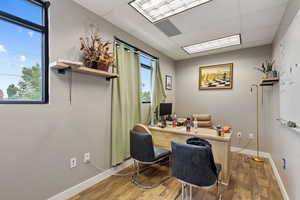 Home office featuring wood finished floors and a paneled ceiling