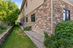 View of home's exterior with stone siding and stucco siding