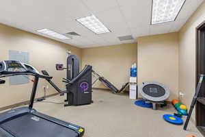 Workout area featuring a drop ceiling