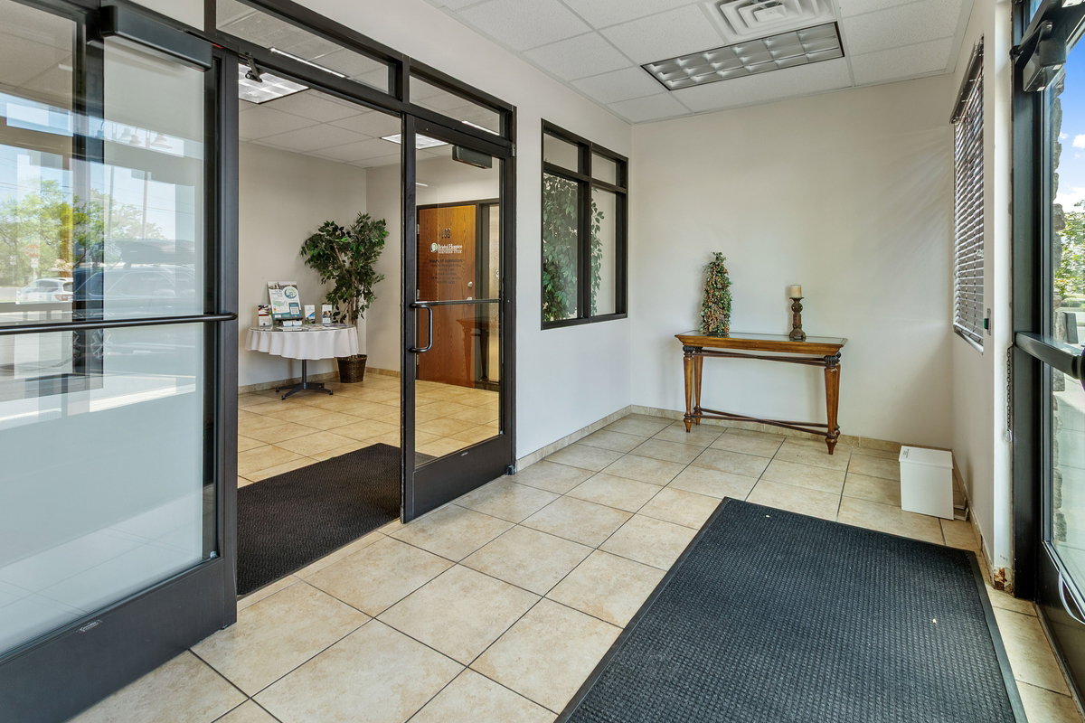 Doorway featuring a paneled ceiling, tile patterned flooring, and french doors