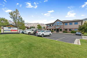 Uncovered parking lot featuring a mountain view