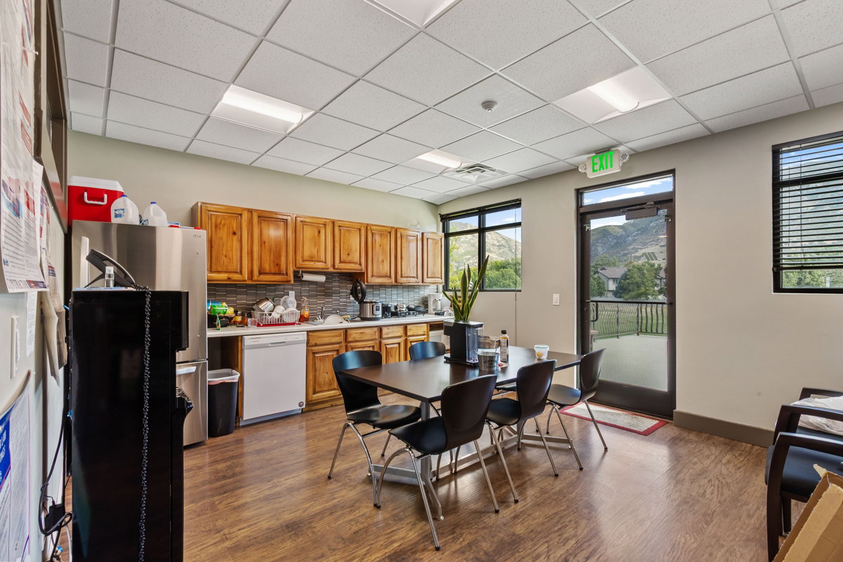 Dining area with a paneled ceiling and dark wood-type flooring