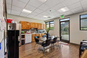 Dining area with a paneled ceiling and dark wood-type flooring