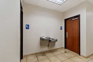 Foyer entrance featuring a paneled ceiling and light tile patterned flooring