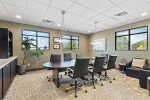 Office area with plenty of natural light, a drop ceiling, and recessed lighting