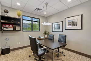 Office with a drop ceiling and recessed lighting