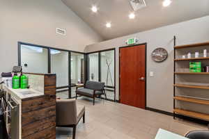 Interior space with recessed lighting and high vaulted ceiling