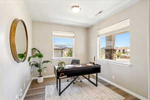 Office area with baseboards and wood finished floors