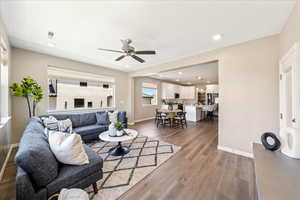 Living area with light wood finished floors, recessed lighting, and a ceiling fan