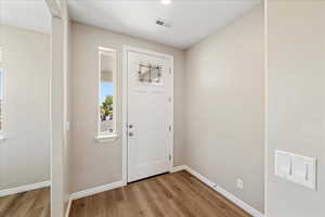 Foyer featuring baseboards and light wood finished floors