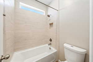 Full bathroom with washtub / shower combination and toilet