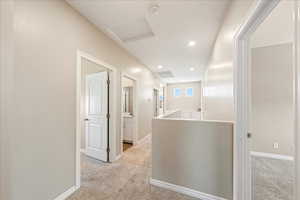 Hallway featuring light colored carpet, an upstairs landing, recessed lighting, and attic access
