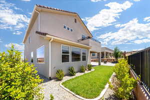 Rear view of house featuring stucco siding and a patio
