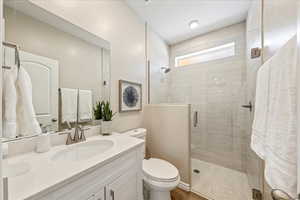 Bathroom featuring vanity and a shower stall