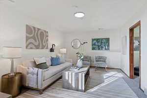 Living area with carpet flooring and baseboards