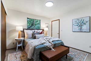 Bedroom with baseboards and a textured ceiling
