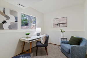 Home office featuring carpet flooring and baseboards