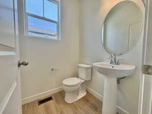 Bathroom featuring baseboards and light wood finished floors