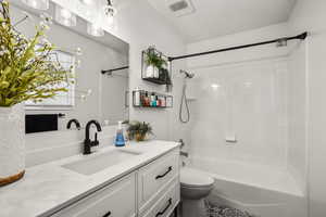 Bathroom with vanity and bathing tub / shower combination