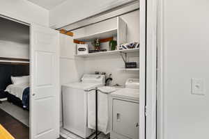Laundry area featuring separate washer and dryer and light wood-style floors