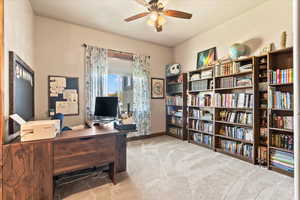 Office space featuring light carpet and ceiling fan