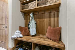 Mudroom with wooden walls and baseboards