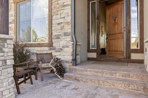 View of exterior entry with stone siding