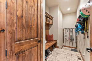 Mudroom with stone tile floors and recessed lighting