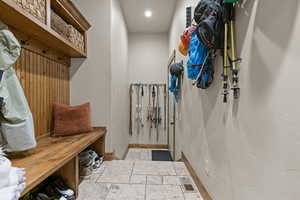 Mudroom featuring stone tile flooring and recessed lighting