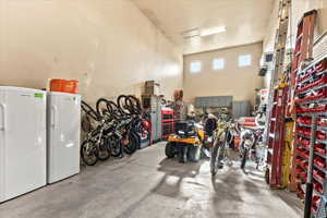 Garage featuring freestanding refrigerator