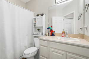 Full bath featuring a shower with shower curtain and vanity