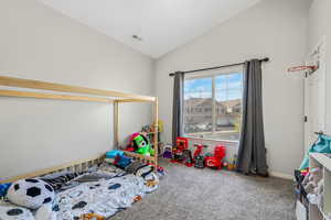 Game room featuring vaulted ceiling and carpet flooring