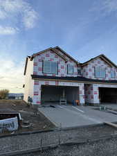 Property in mid-construction with concrete driveway and an attached garage