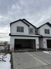 View of front of property with an attached garage and driveway