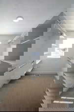 Spacious closet with light carpet