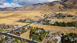 Aerial overview of property's location featuring nearby suburban area and a mountainous background