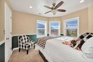 Carpeted bedroom with recessed lighting, a ceiling fan, and a textured ceiling