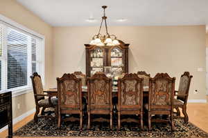 Dining area featuring a chandelier and light wood-style floors