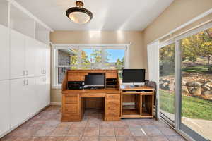 Office featuring light tile patterned flooring and baseboards