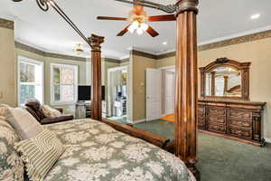 Primary Bedroom featuring ornamental molding, carpet floors, and a ceiling fan